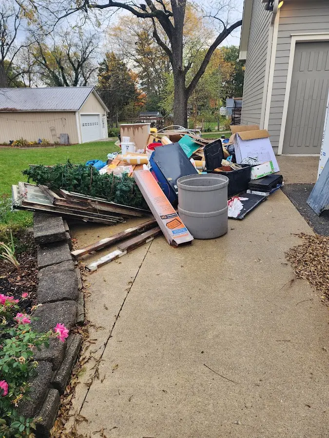 Dumpster being loaded with debris for Estate Cleanout Dumpster Rental in Shawnee